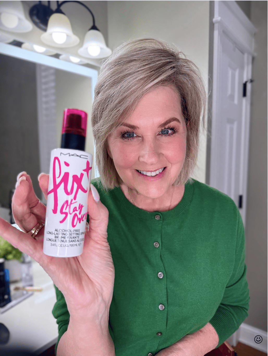 Tania Stephens in a green sweater with MAC fix it stay over spray makeup from Nordstrom Beauty